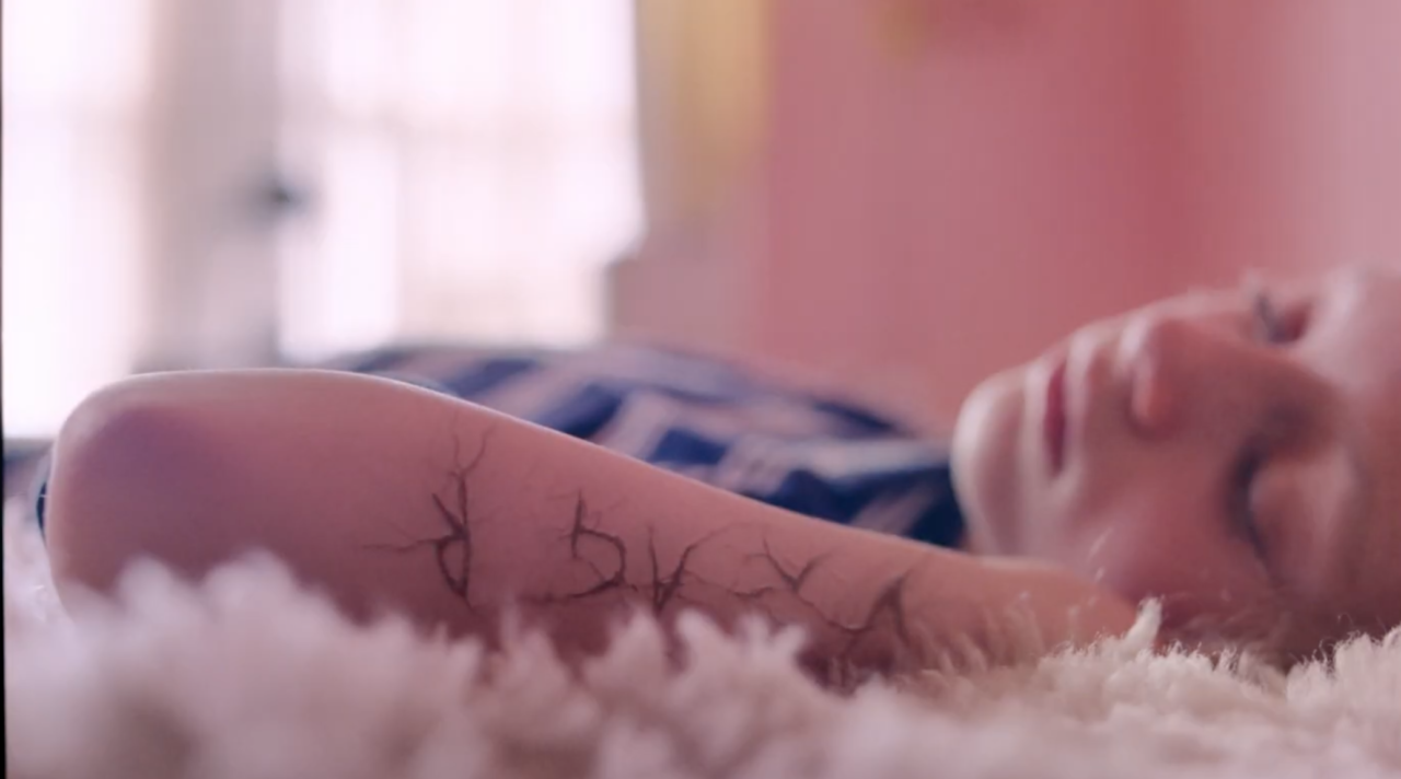 a still from the UNICEF campaign film showing a child lying on a bed